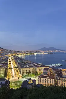 Naples, Campania, Italy. View of the bay by night and Mount Vesuvius Volcano in background