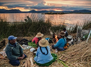 Native Uro Family dining at sunset, Uros Floating Islands, Lake Titicaca, Puno Region