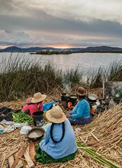 Lake Titicaca Gallery: Native Uro Family preparing a meal, Uros Floating Islands, Lake Titicaca, Puno Region