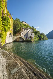 Nesso, lake Como, Como province, Italy. Lake shore and the roman stone bridge Nesso, lake Como, Como province, Italy. Lake shore and the roman stone bridge
