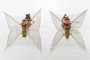 Net casting fishermen on the Perfume River, Hue, Vietnam