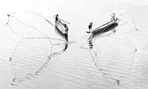Net casting fishermen on the Perfume River, Hue, Vietnam
