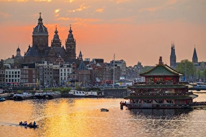 Netherlands, North Holland, Amsterdam. City skyline at sunset with domes of Basilica