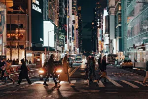New York City streets at night, people and city lights, USA