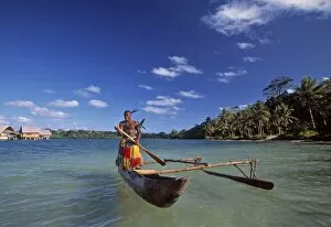 Ni-Vanuatu warrior rowing a canoe, Vanuatu