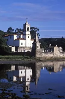 Church Tower Gallery: Niembro Church sits on the shore of a quiet inlet on the Asturian coast