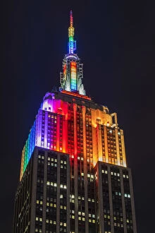 Images Dated 14th December 2015: Night low angle view of the Empire State Building with rainbow colors, Manhattan