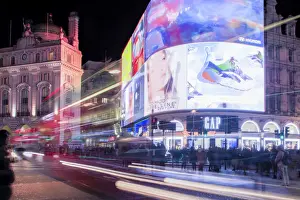 Hoardings Prints: A night shot of light trails in front of the advertising hoardings in Piccadilly Circus