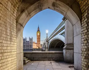Night view of Big Ben and Westminster Palace from an old alley on the river bank