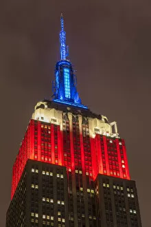 Night view of the Empire State Building with red, white and blue colors in honor of