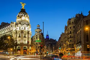 Night view of Gran Via street and Metropolis Building with car light trails, Madrid