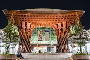 Night view of huge wooden gate marking the entrance to Kanazawa JR Station Building