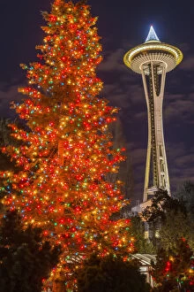 Night view of Space Needle and Christmas tree at Seattle Center, Seattle, Washington, USA