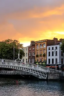 Northern Europe; Dublin, Halfpenny bridge and Liffey river at sunset