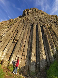 Basalt Prints: Northern Ireland, County antrim, Giants causeway, woman at base of organ