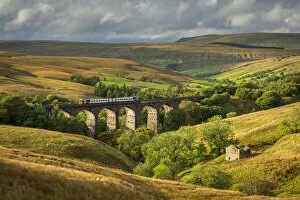 Northern Railway passenger train crossing Dent Head Viaduct in the Yorkshire Dales National Park, Yorkshire, England