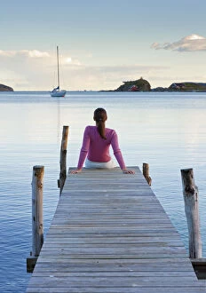 Relaxation Gallery: Norway, Oslo, Oslo Fjord, Woman sitting on jetty over lake (MR)