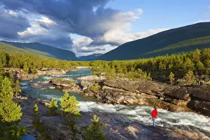 Norway, Western Fjords, Woman standing by Otto river near Lom (MR)