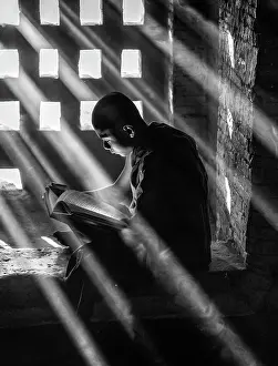 Inside Prints: Novice Buddhist Monk studying in the window of an ancient temple, Bagan, Myanmar