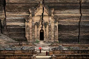Religious Place Collection: Two novice monks walking towards unfinished Pahtodawgyi pagoda known for a crack caused
