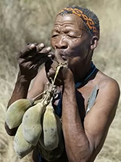 Bushman Gallery: A N!!S hunter-gatherer lights his pipe to relax having