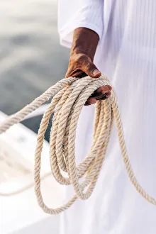 Nubian sailor on his felucca boat on the Nile River, Aswan, Upper Egypt, Egypt, Africa