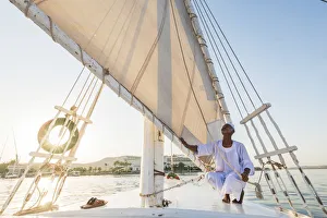 Nubian sailor on his felucca boat on the Nile River, Aswan, Upper Egypt, Egypt, Africa
