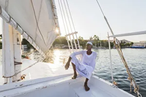 Nubian sailor on his felucca boat on the Nile River, Aswan, Upper Egypt, Egypt, Africa