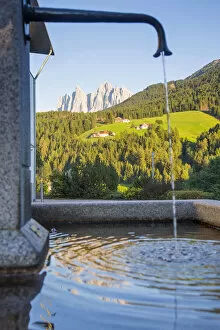 Odle peaks reflected in a fountain, Dolomites, South Tyrol, Trentino Alto Adige, Italy