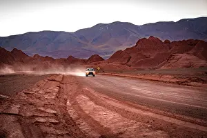Tracks Prints: Off-road vehicle traveling on an empty road