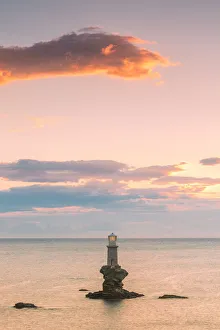 Cloudy Prints: The offshore Tourlitis lighthouse at a cloudy sunset, Andros, Cyclades Archipelago