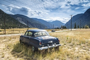 Old abandoned American car by road, British Columbia, Canada