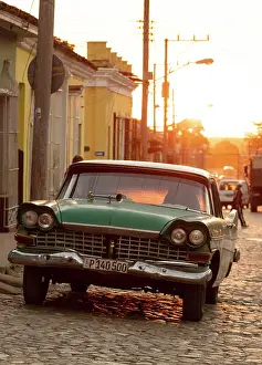 Cobbled Street Prints: Old American car parked on a cobbled street at sunset in the historic town of Trinidad