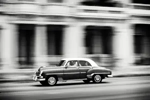 Classic Prints: Old American car speeding along The Malecon (waterfront) Havana Centro