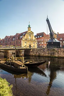 Luneburg Prints: Old barges on the Ilmenau with old department store, Luneburg, Lower Saxony, Germany