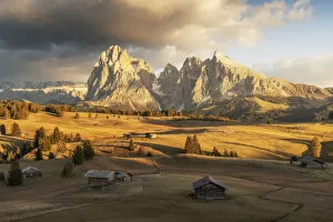 Wind Gallery: Some old cabins lost in the meadows of the Alpe di Siusi (Seiser Alm) during an early autumn sunset