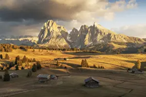 Wind Prints: Some old cabins lost in the meadows of the Alpe di Siusi (Seiser Alm) during an early autumn sunset