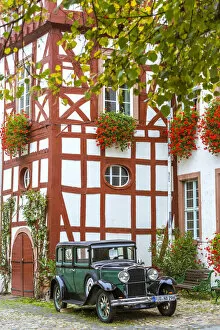 Images Dated 7th December 2015: Old classical car in front of traditional building, Rudesheim, Rhine valley, Hesse