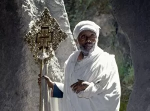 African Man Gallery: An old Ethiopian Orthodox priest holds a large brass