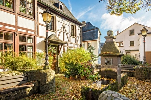 Moselle Prints: The old fountain with half-timbered houses in Bremm on the Mosel