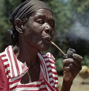 African Culture Gallery: An old Luo lady smoking a traditional clay pipe