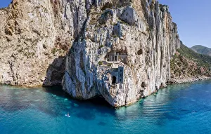 Old mining area in the rock above the turquoise sea in Sardinia, Italy. Porto Flavia