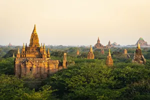Stupas Prints: Old pagodas amidst trees against sky during sunrise, Bagan, Mandalay Region, Myanmar