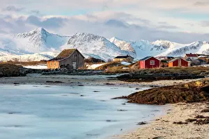 Sommeroy Prints: Old red wooden barn (rorbu) and snow-covered mountains, Sommeroy, near Tromso, Norway