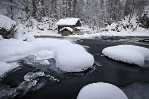 Mill Prints: Old mill in a snowy forest overlooking a frozen river in winter