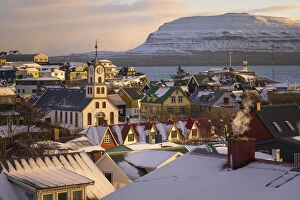 Images Dated 27th January 2022: The old part of Torshavn covered by snow. In the background the island of Nolsoy