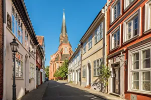 Alley Prints: Old town street with St. Nicolai church, Luneburg, Lower Saxony, Germany