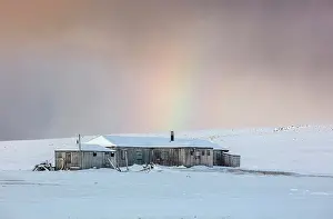 Rainbow Prints: Old wooden cabins with rainbow in the background