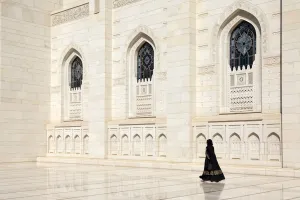 Construction Prints: An Omani woman walks past the marble facade of Sultan Qaboos Grand Mosque, Muscat, Oman