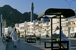 Corniche Prints: Omanis walk and sit alongside Muttrahs busy Corniche